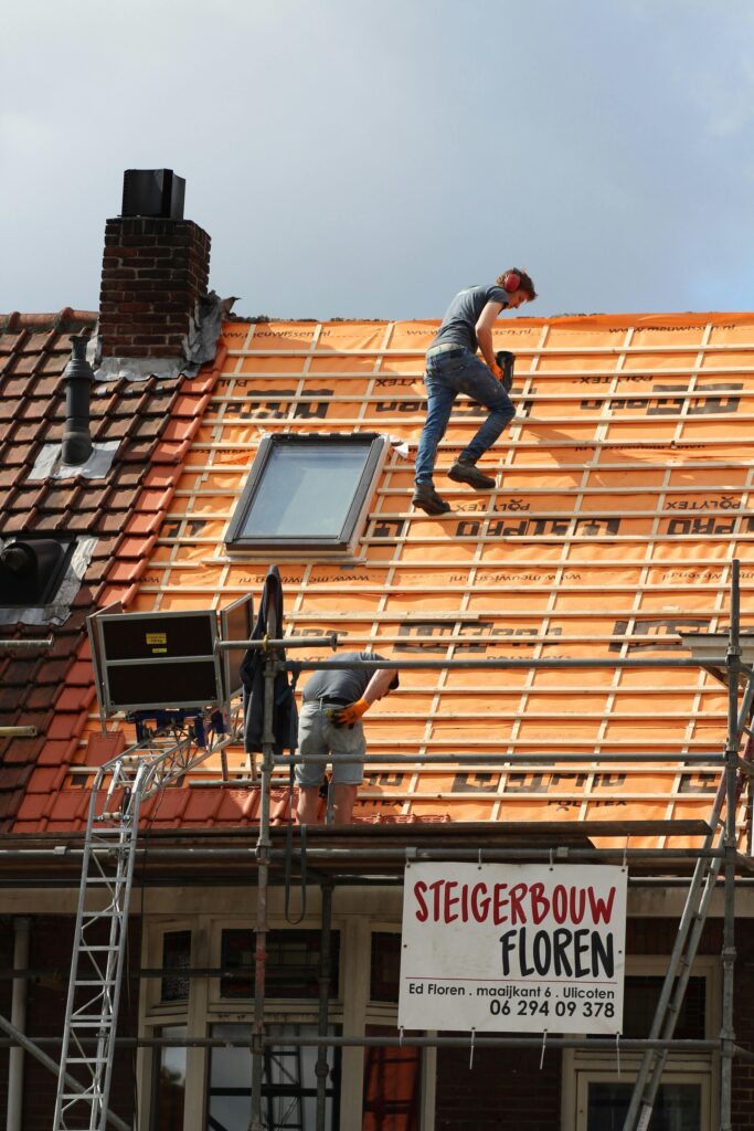 pexels photo 11784496 11784496 Construction workers installing new roof tiles in the Netherlands.